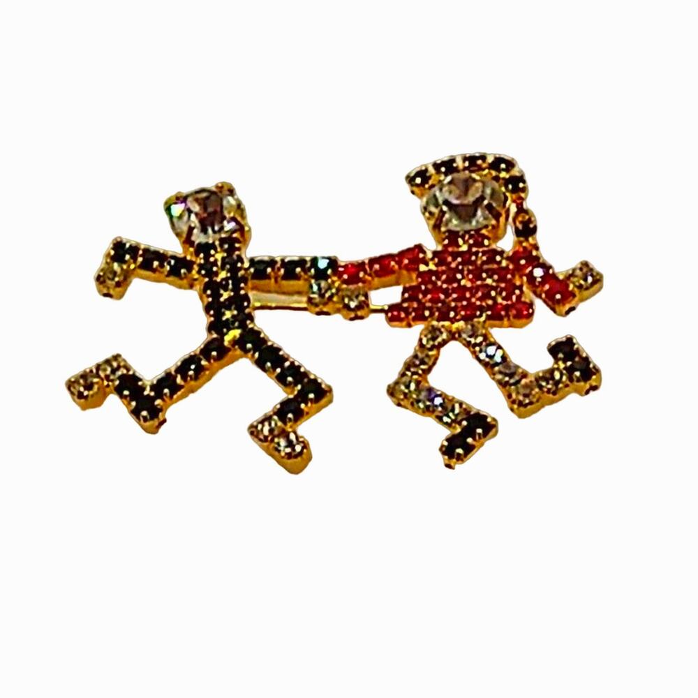 Rhinestone dancers brooch. Red/black/clear on gold tone.